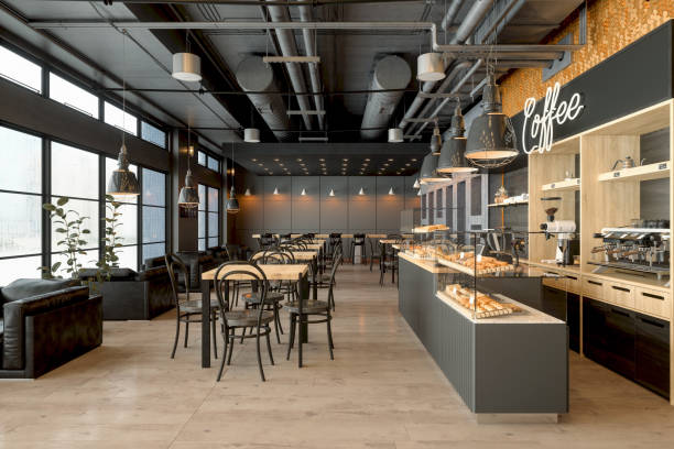 An interior view of the Jelly Cafe showcasing an avant-garde architectural design with soft, curved walls and glassmorphic partitions. The room is filled with organic-shaped furniture in creamy pearl and seafoam tones.